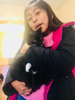 young girl holding a cat